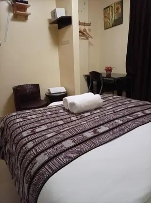 a bed with a white towel on top of it at Machupicchu Royal Mountain in Machu Picchu