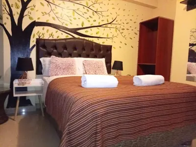 a bedroom with a bed with a tree mural on the wall at Machupicchu Royal Mountain in Machu Picchu