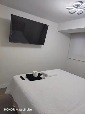 a bedroom with a bed and a flat screen tv at Departamento The Lead 509 con Piscina in Lima