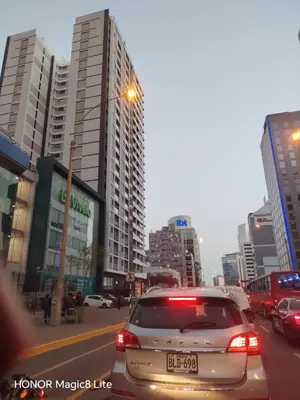 a car driving down a city street with buildings at Departamento The Lead 509 con Piscina in Lima