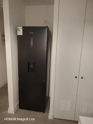 a black refrigerator in the corner of a room at Departamento The Lead 509 con Piscina in Lima
