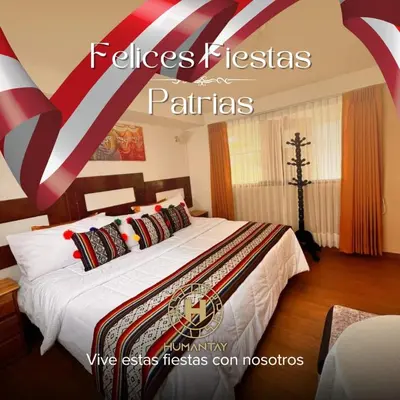 a bedroom with a large bed with red and white pillows at Hotel MachuPicchu Humantay in Machu Picchu