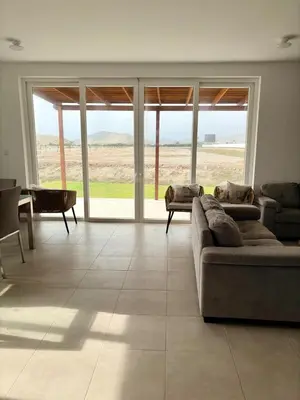 a living room with a couch and a table at Casa de playa en Cerro Azul con piscina privada in Cerro Azul