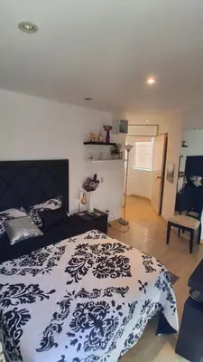 a bedroom with a bed with a blue and white blanket at Casa Portada del Sol La Molina in Lima