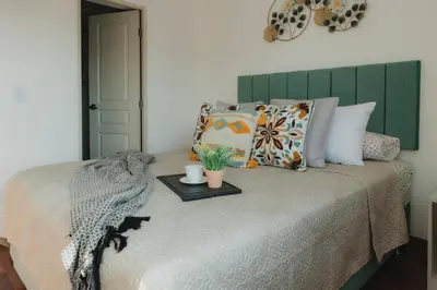 a bedroom with a bed with a green headboard at Recavarren 3 Dormitorios by Casa Miraflores - Wifi - Washer - Hot Water in Lima