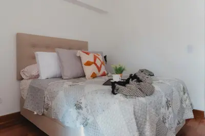 a bed with a blanket and pillows on it at Recavarren 3 Dormitorios by Casa Miraflores - Wifi - Washer - Hot Water in Lima