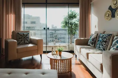 a living room with two couches and a table at Recavarren 3 Dormitorios by Casa Miraflores - Wifi - Washer - Hot Water in Lima