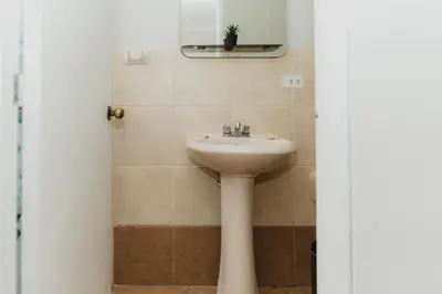 a bathroom with a sink and a mirror at Galvez 3 Dormitorios by Casa Miraflores - Wifi Washer Hot Water in Lima