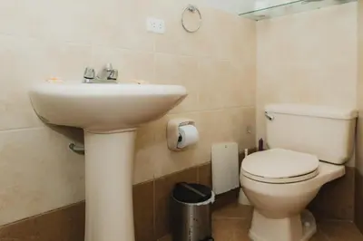 a bathroom with a sink and a toilet at Galvez 3 Dormitorios by Casa Miraflores - Wifi Washer Hot Water in Lima
