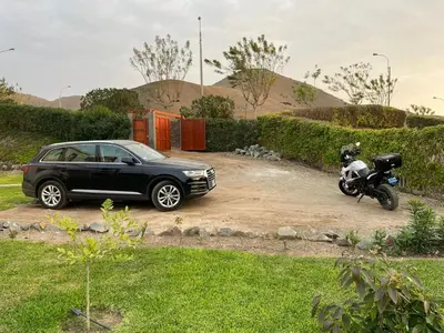 a car and a motorcycle parked in a driveway at Casa de Campo Azpitia Perú in Santa Cruz de Flores