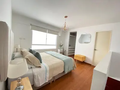 a white bedroom with a bed and a window at Mendiburu 2 Dormitorios by Casa Miraflores - Wifi - Hot Water in Lima