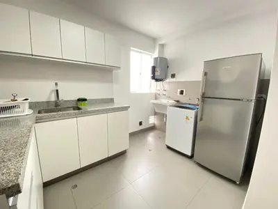 a kitchen with white cabinets and a stainless steel refrigerator at Mendiburu 2 Dormitorios by Casa Miraflores - Wifi - Hot Water in Lima