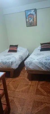 two beds sitting next to each other in a room at AMARU Palace in Machu Picchu
