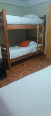 two bunk beds in a room with a bed at AMARU Palace in Machu Picchu