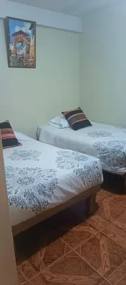 two beds sitting next to each other in a room at AMARU Palace in Machu Picchu