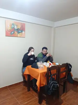 two people sitting at a table drinking coffee at AMARU Palace in Machu Picchu