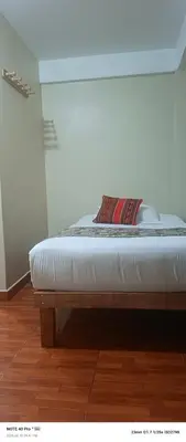 a bed in a room with a white mattress at AMARU Palace in Machu Picchu