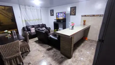 a living room with a couch and a table and chairs at Victoria home san blas in Cusco