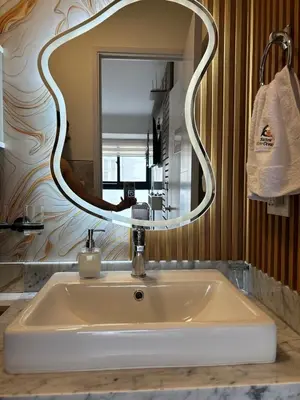 a bathroom sink with a large mirror above it at Luxury Ocean View Barranco Apt, 17th Floor AC in Lima