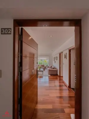 a hallway with a door open to a living room at Cozy Retreat in the Heart of Surco in Lima