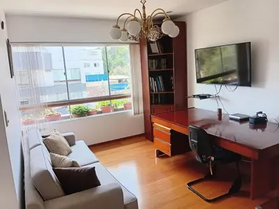 a living room with a desk and a couch at Cozy Retreat in the Heart of Surco in Lima
