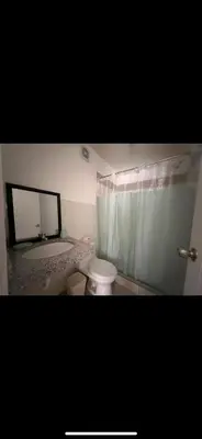 a bathroom with a white toilet and a sink at Habitación con baño privado, duplex con ambientes compartidos in Lima