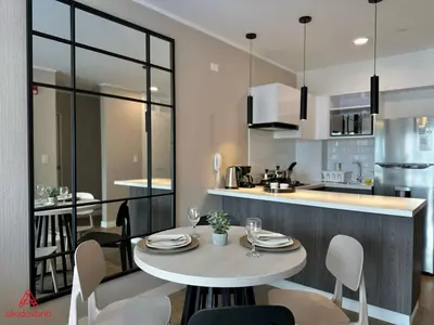 a kitchen with a table and chairs in a room at Fantastic 1BR at Barranco in Lima
