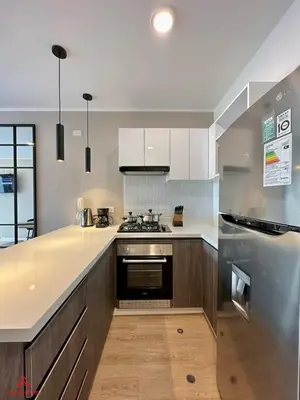 a kitchen with white counters and a stove top oven at Fantastic 1BR at Barranco in Lima