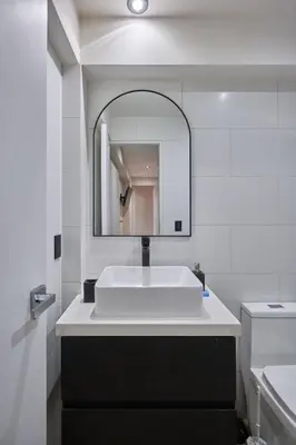 a white bathroom with a sink and a mirror at Geko | Contemporary 2BR w/Balcony near Costa Verde in Lima