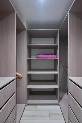 a walk in closet with a pink towel on the shelves at Geko | Contemporary 2BR w/Balcony near Costa Verde in Lima