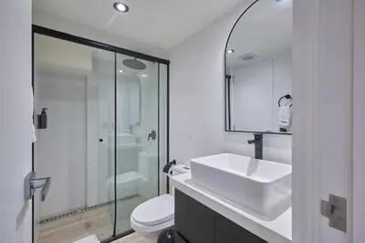 a bathroom with a sink and a toilet and a shower at Geko | Contemporary 2BR w/Balcony near Costa Verde in Lima