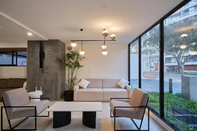 a living room with a couch and chairs and a table at Geko | Contemporary 2BR w/Balcony near Costa Verde in Lima