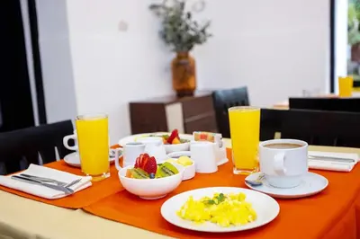a table with breakfast foods and drinks on it at San Blas Plaza Hotel in Cusco