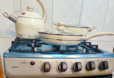 a stove with pots and pans on top of it at 3 bedroom apartment Ayacucho - Perú in Ayacucho
