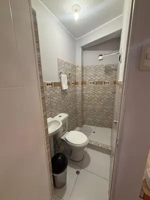 a small bathroom with a toilet and a sink at 3 bedroom apartment Ayacucho - Perú in Ayacucho