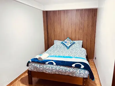 a small bedroom with a bed with a pillow at Casa de Paz in Cusco