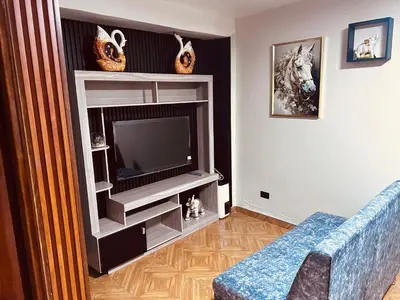 a living room with a tv and a blue couch at Casa de Paz in Cusco