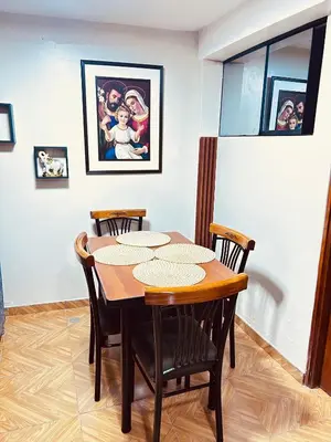 a dining room with a table and four chairs at Casa de Paz in Cusco