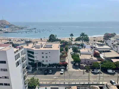 an aerial view of a city and the ocean at Departamento cerca al mar con terraza panoramica in Lima