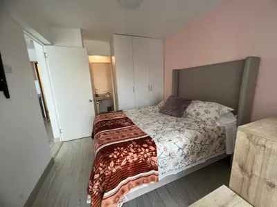 a bedroom with a large bed in a room at Departamento cerca al mar con terraza panoramica in Lima