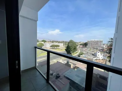 a balcony with a view of a city at Departamento cerca al mar con terraza panoramica in Lima