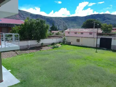 a view of a yard with mountains in the background at Wasi Wasi in Urubamba