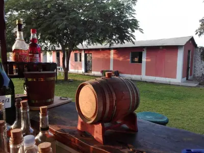 a barrel sitting on top of a table with bottles at La Viña de OsCar in Nuevo Imperial
