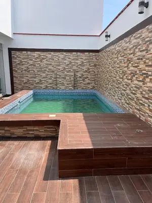 a swimming pool in a room with a brick wall at Casa de playa con Piscina I-101 in Punta Negra