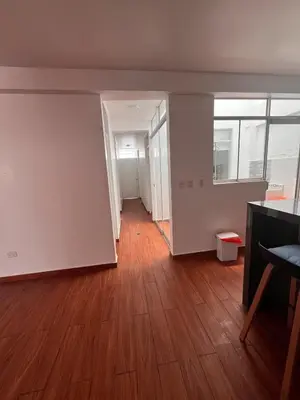 an empty living room with a wooden floor at Casa de playa con Piscina I-101 in Punta Negra