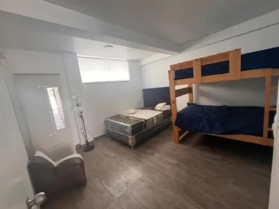 a bedroom with a bunk bed and a ladder at Casa de playa con piscina 2 in Punta Negra