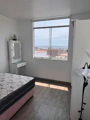 a bedroom with a bed and a large window at Casa de playa con piscina 2 in Punta Negra