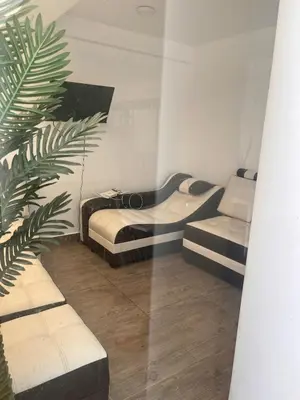 a room with two beds and a plant in it at Casa de playa con piscina 2 in Punta Negra