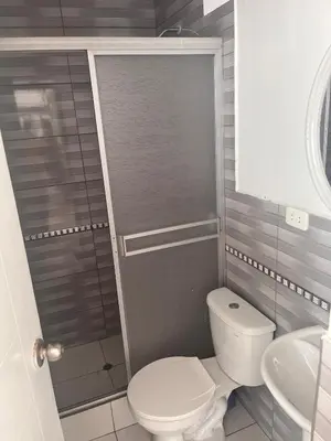 a bathroom with a toilet and a sink at Casa de playa con piscina 2 in Punta Negra
