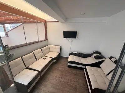 a living room with two couches and a television at Casa de playa con piscina 2 in Punta Negra